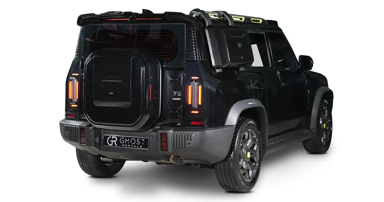 Sleek black Jetour T2 SUV cruising Dubai streets, reflecting modern architecture and lights