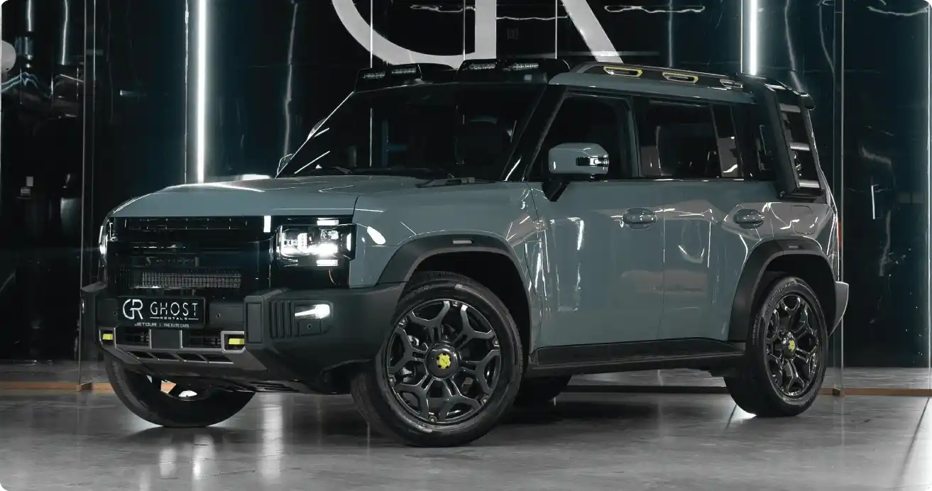 DEFENDER KIT hire — rugged SUV with roof rack on rocky trail