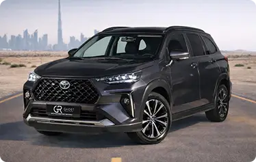 Toyota Veloz parked by Dubai skyline for rent — spacious family SUV